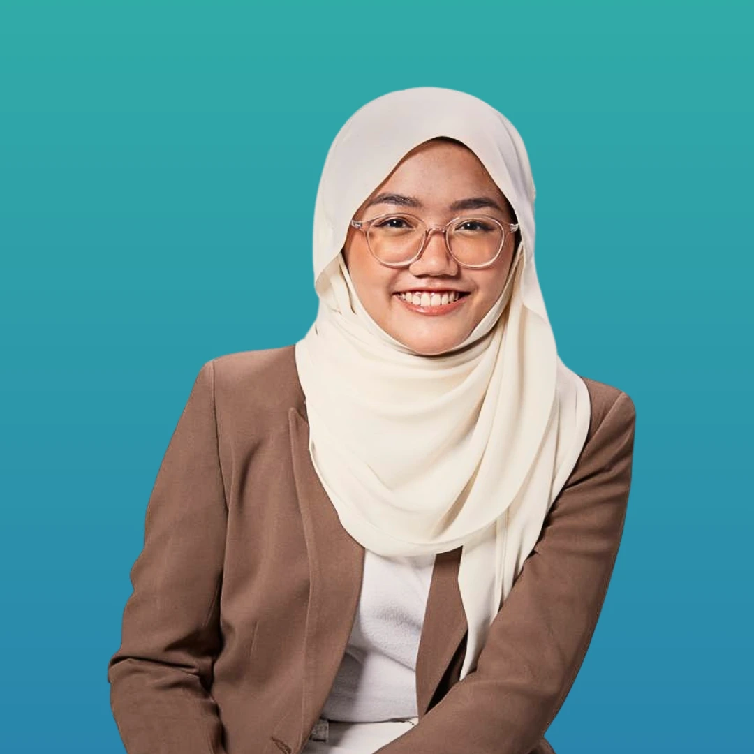 Anis is seen smiling, she is wearing brown jacket with white shirt