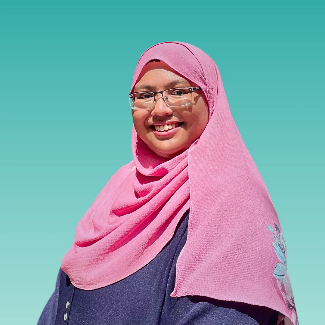 Zafiera Zainal is wearing pink hijab and smiling in front of the camera